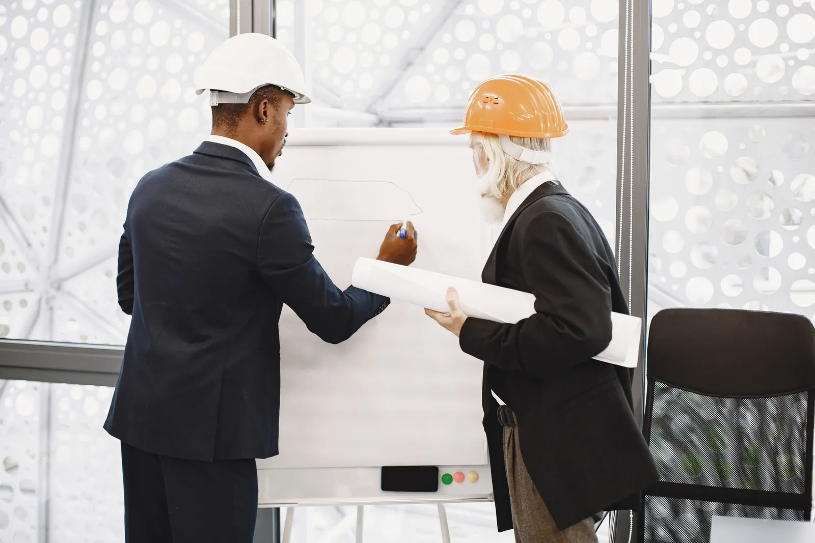 Team reviewing bid documents and project drawings at a conference table