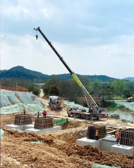 Crane and concrete work underway at an early-stage construction site