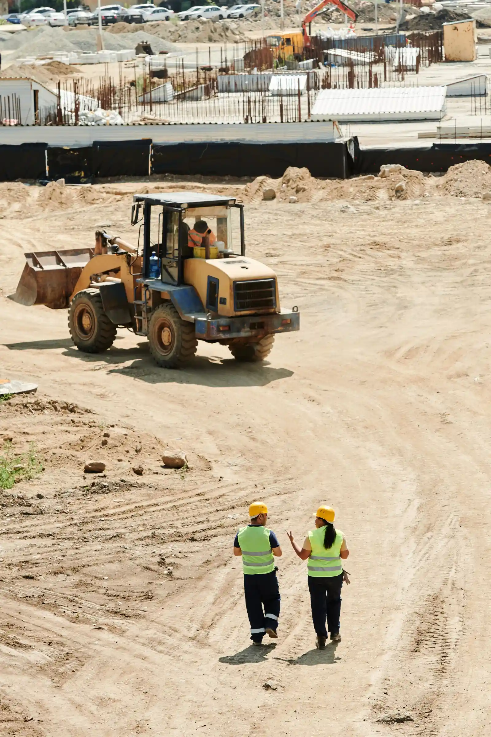Construction workers walking a jobsite together during a trade coordination walk
