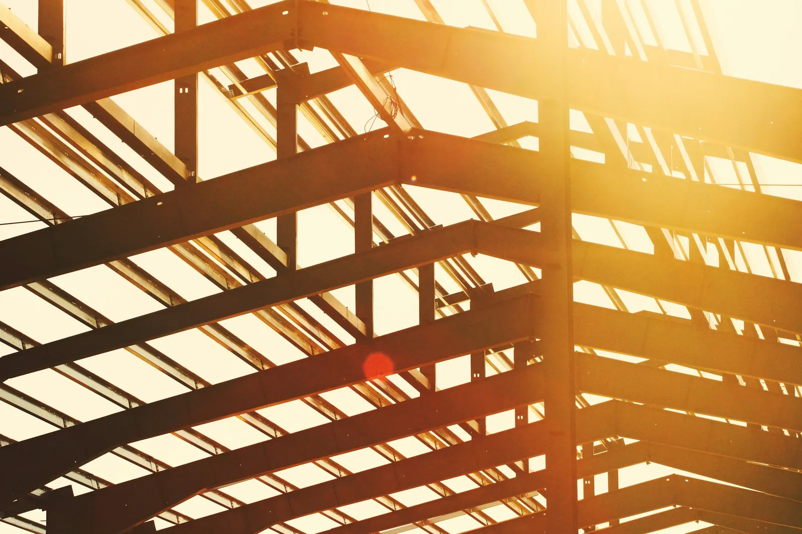 Structural steel framing against the sky at a construction site