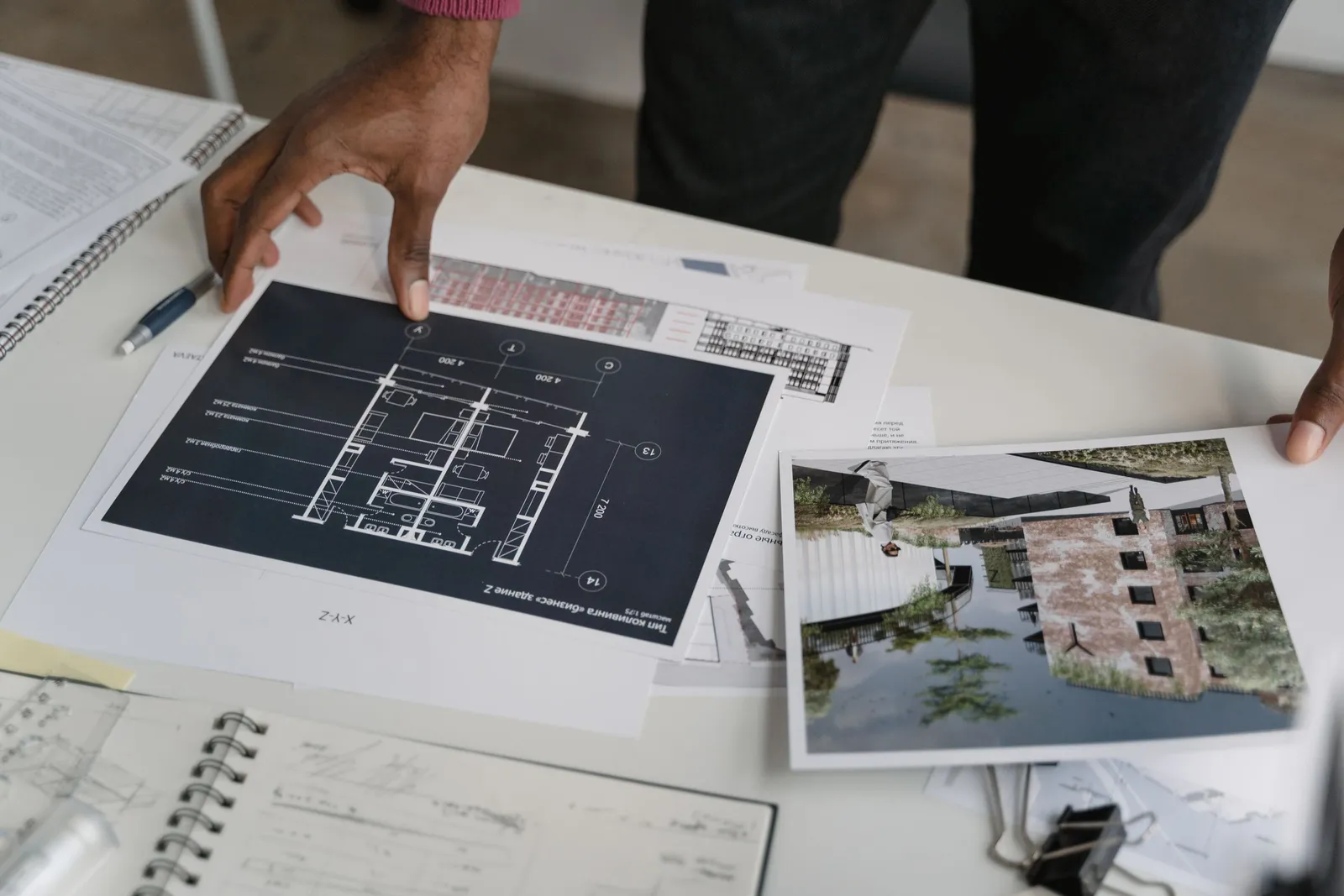 Two people reviewing blueprints together