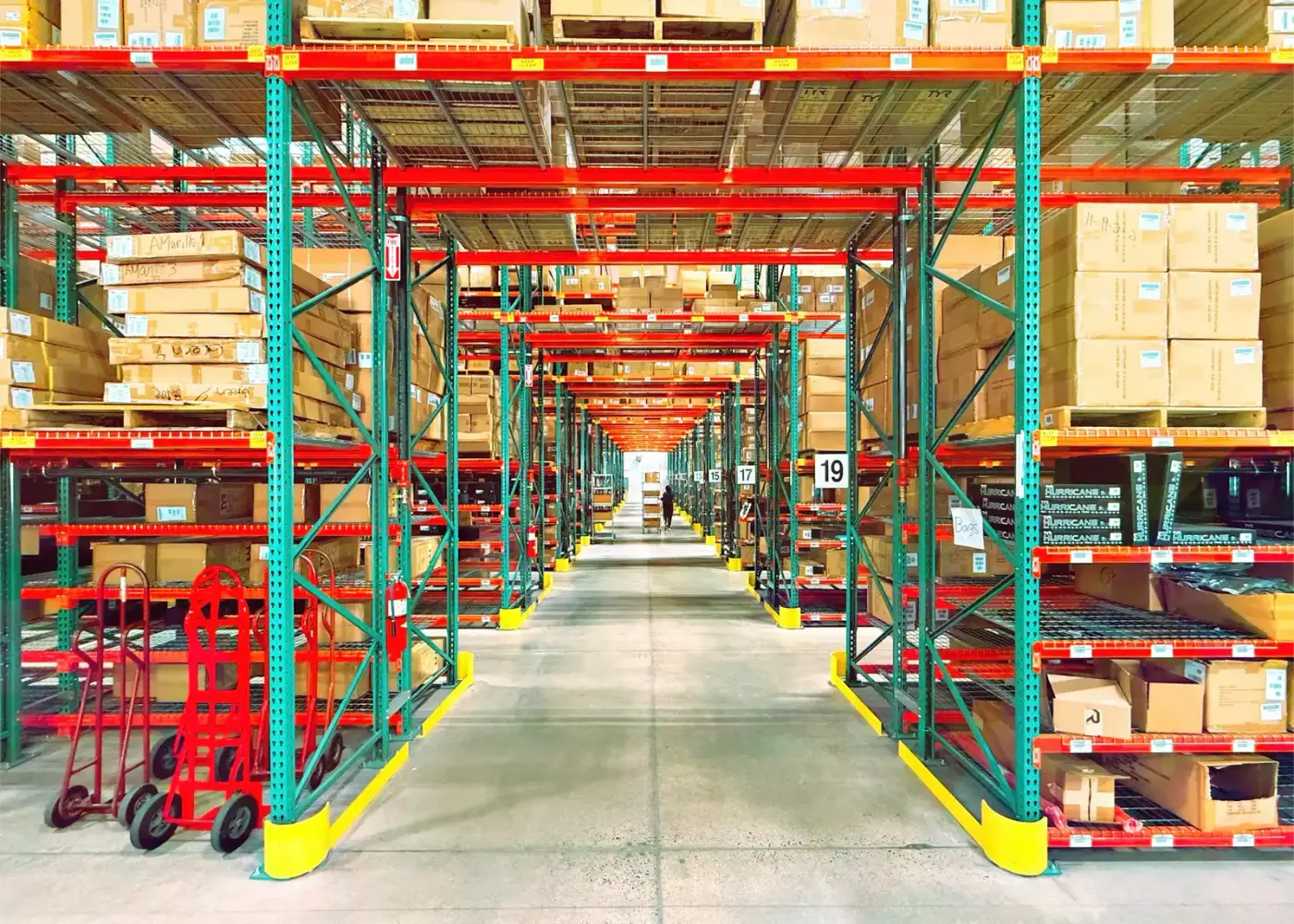 Interior of a large industrial warehouse with high ceilings and racking